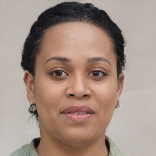 Joyful black young-adult female with short  brown hair and brown eyes