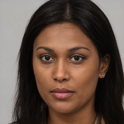 Neutral black young-adult female with long  brown hair and brown eyes