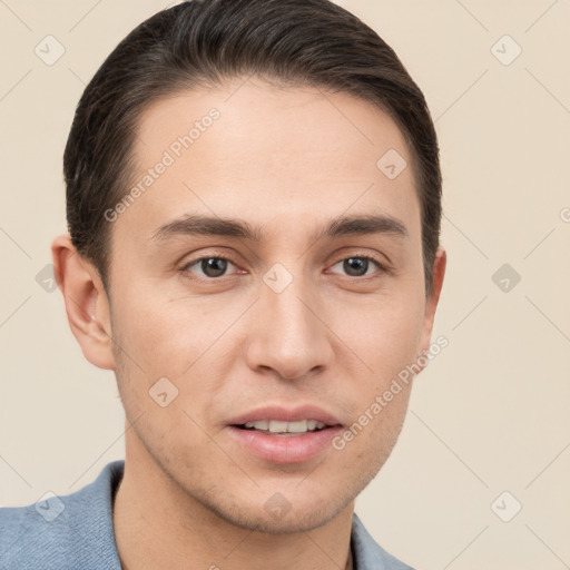 Joyful white young-adult male with short  brown hair and grey eyes