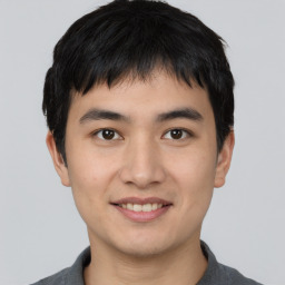 Joyful asian young-adult male with short  black hair and brown eyes