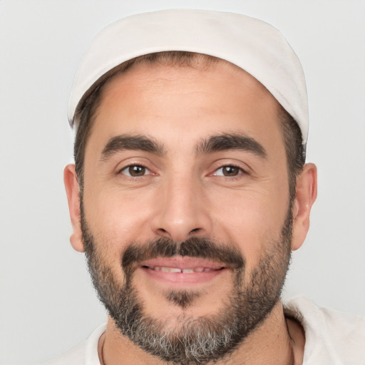 Joyful white adult male with short  black hair and brown eyes