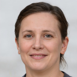 Joyful white adult female with short  brown hair and grey eyes