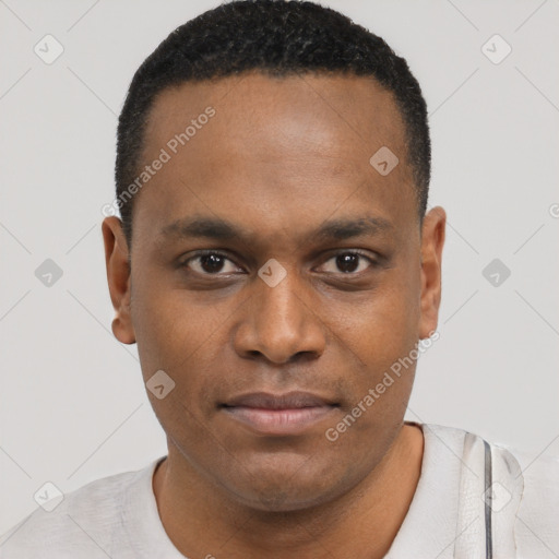 Joyful black young-adult male with short  brown hair and brown eyes