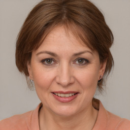 Joyful white adult female with medium  brown hair and brown eyes