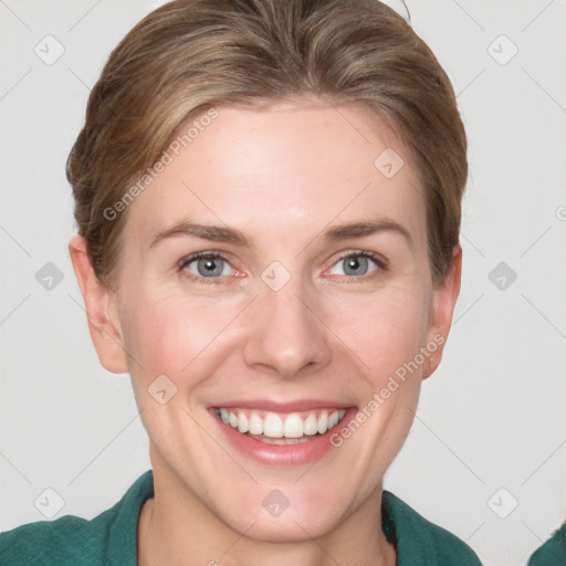 Joyful white young-adult female with short  brown hair and blue eyes