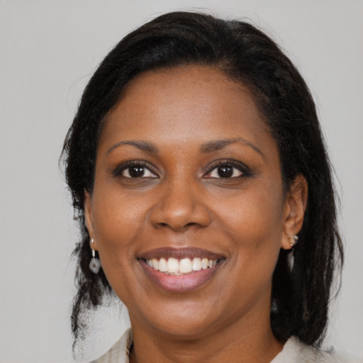 Joyful black young-adult female with medium  brown hair and brown eyes