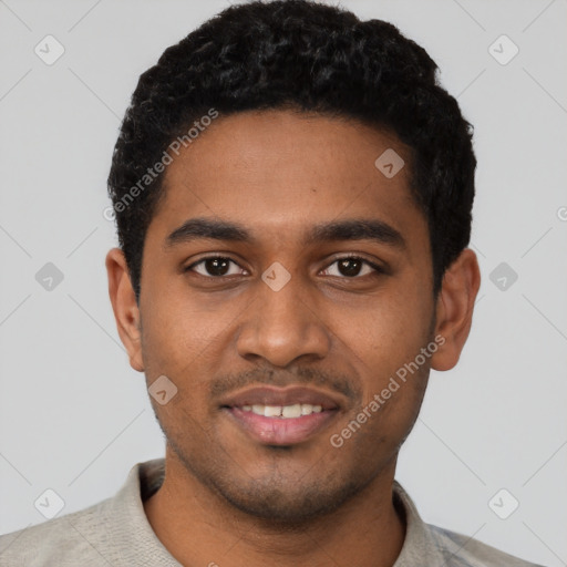 Joyful black young-adult male with short  black hair and brown eyes