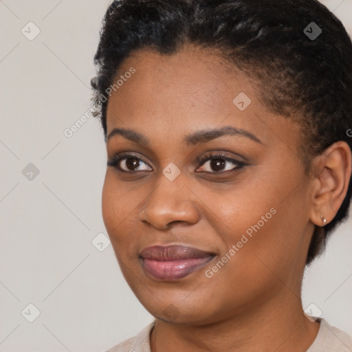 Joyful black young-adult female with short  brown hair and brown eyes