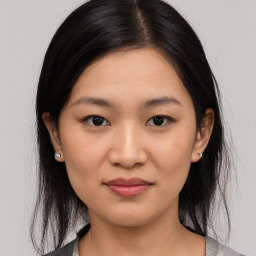 Joyful asian young-adult female with medium  black hair and brown eyes