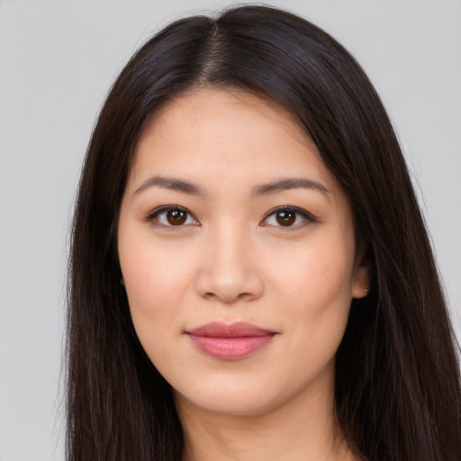 Joyful latino young-adult female with long  brown hair and brown eyes