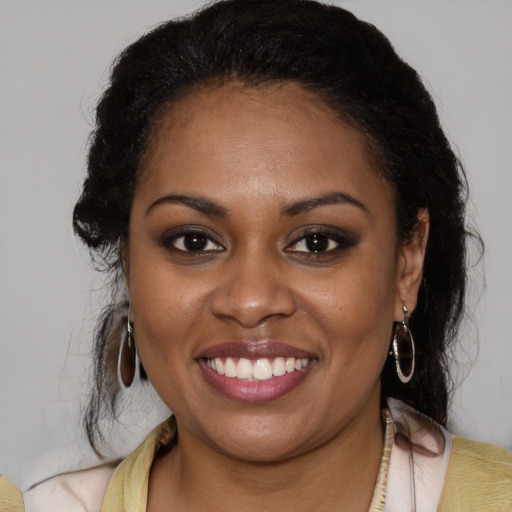 Joyful latino young-adult female with medium  brown hair and brown eyes