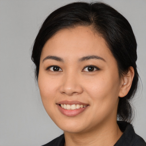 Joyful asian young-adult female with long  black hair and brown eyes