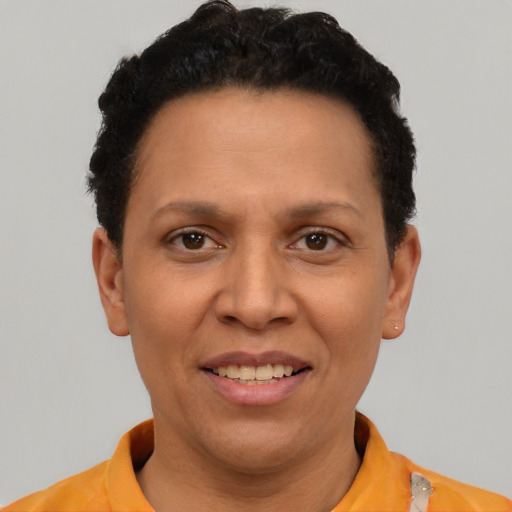 Joyful black young-adult female with short  black hair and brown eyes