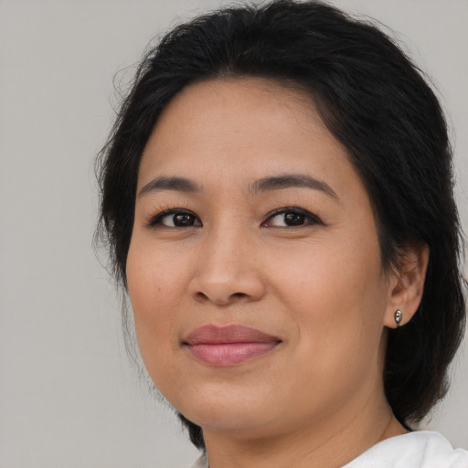 Joyful asian young-adult female with medium  brown hair and brown eyes