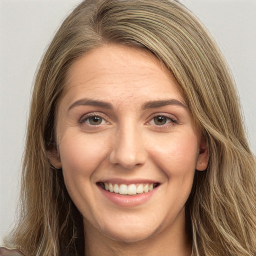 Joyful white young-adult female with long  brown hair and brown eyes