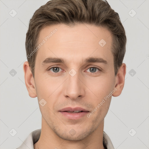 Joyful white young-adult male with short  brown hair and grey eyes