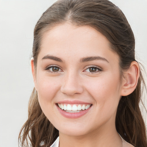 Joyful white young-adult female with long  brown hair and grey eyes