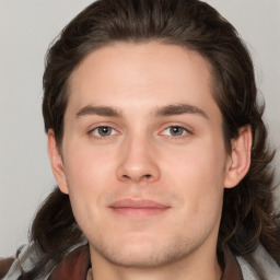 Joyful white young-adult male with medium  brown hair and brown eyes