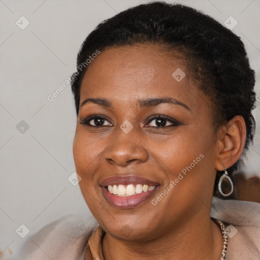 Joyful black young-adult female with short  brown hair and brown eyes