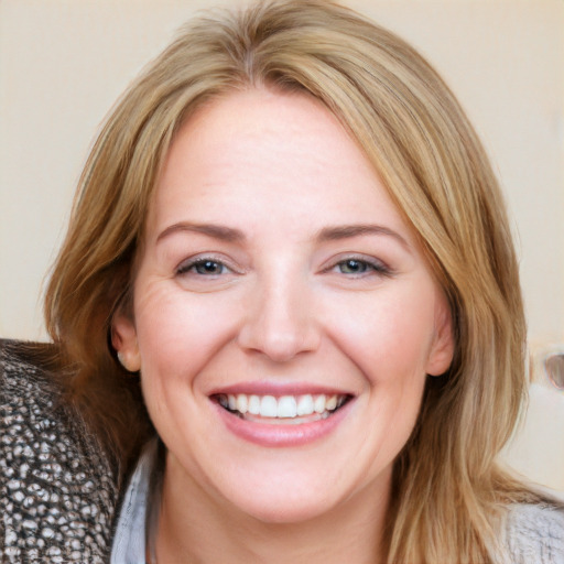 Joyful white young-adult female with medium  brown hair and blue eyes