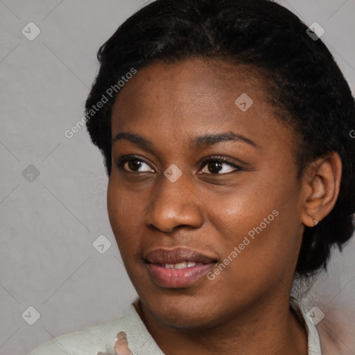 Joyful black young-adult female with short  black hair and brown eyes