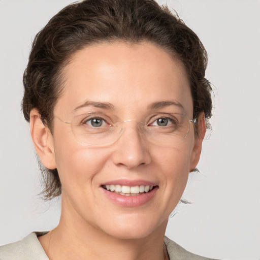 Joyful white adult female with medium  brown hair and grey eyes