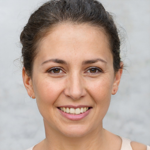 Joyful white adult female with short  brown hair and brown eyes