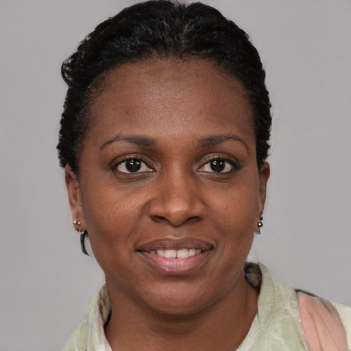 Joyful black adult female with short  black hair and brown eyes