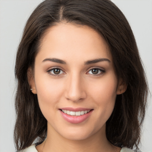 Joyful white young-adult female with medium  brown hair and brown eyes