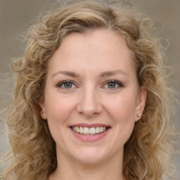 Joyful white young-adult female with medium  brown hair and green eyes