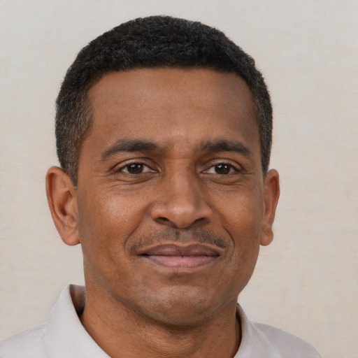 Joyful latino adult male with short  brown hair and brown eyes