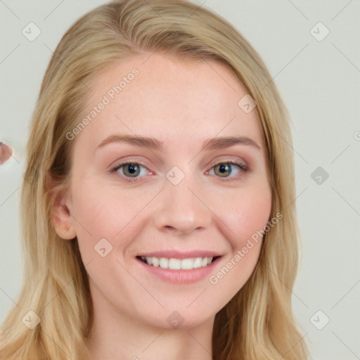 Joyful white young-adult female with long  brown hair and blue eyes