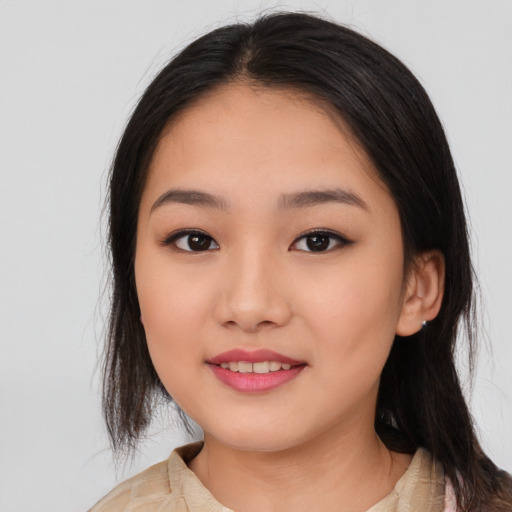 Joyful asian young-adult female with medium  black hair and brown eyes