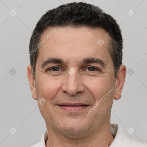 Joyful white adult male with short  brown hair and brown eyes