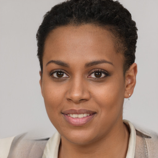 Joyful black young-adult female with short  brown hair and brown eyes