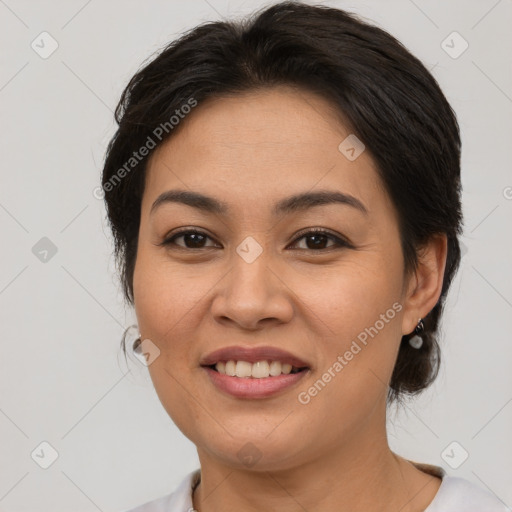 Joyful latino young-adult female with medium  brown hair and brown eyes