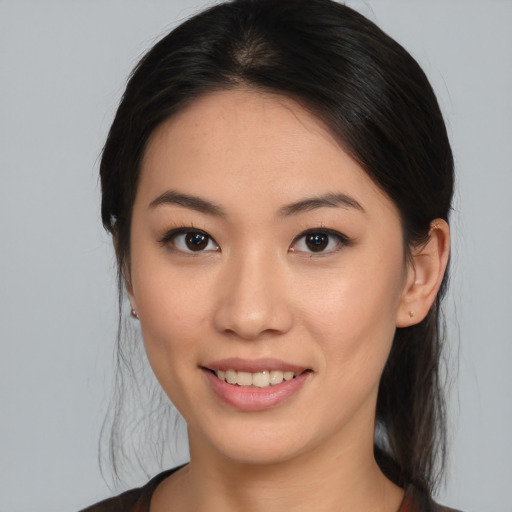 Joyful asian young-adult female with medium  brown hair and brown eyes