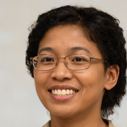Joyful latino adult female with short  brown hair and brown eyes