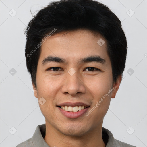 Joyful asian young-adult male with short  black hair and brown eyes