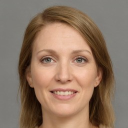 Joyful white adult female with medium  brown hair and grey eyes