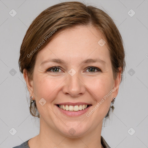 Joyful white adult female with medium  brown hair and grey eyes