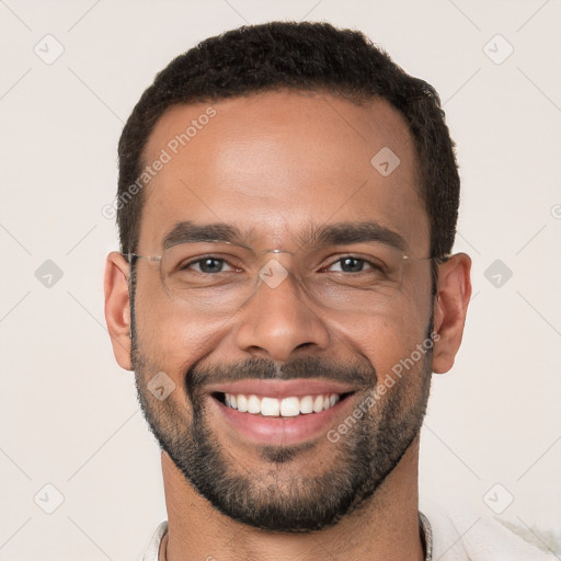 Joyful white young-adult male with short  black hair and brown eyes