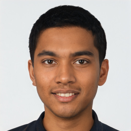 Joyful latino young-adult male with short  black hair and brown eyes