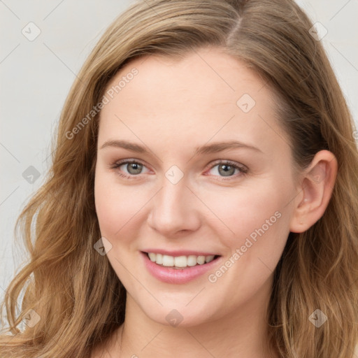 Joyful white young-adult female with long  brown hair and blue eyes