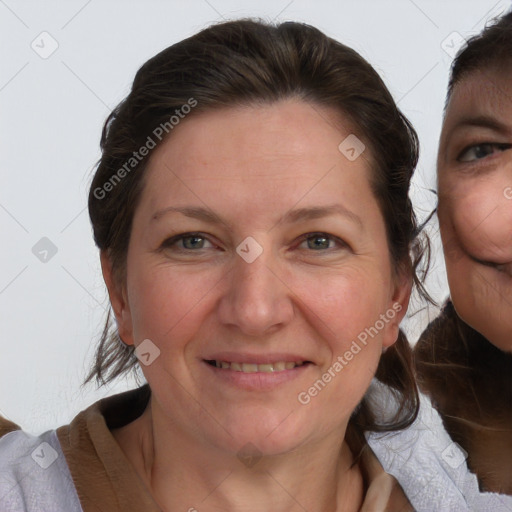 Joyful white adult female with medium  brown hair and blue eyes