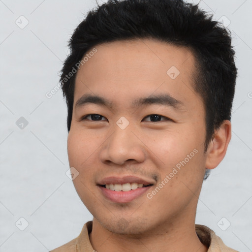 Joyful asian young-adult male with short  black hair and brown eyes