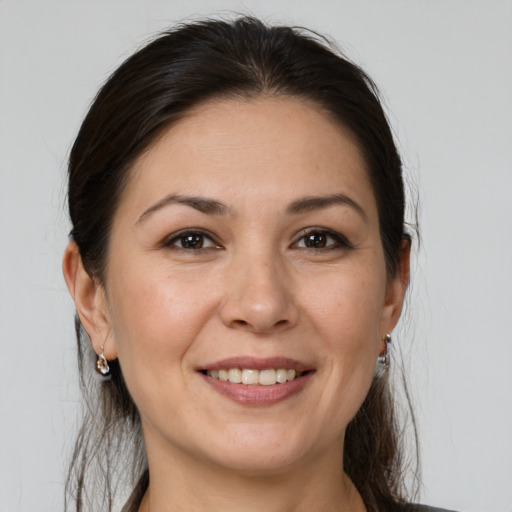 Joyful white adult female with medium  brown hair and brown eyes