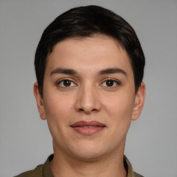 Joyful white young-adult male with short  black hair and brown eyes