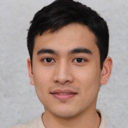 Joyful asian young-adult male with short  black hair and brown eyes