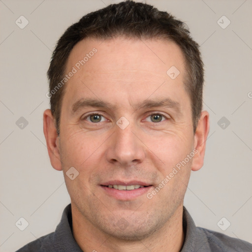 Joyful white adult male with short  brown hair and brown eyes